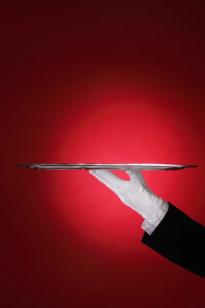 Butler carrying silver serving tray, close-up of hand — Stock Photo, Image