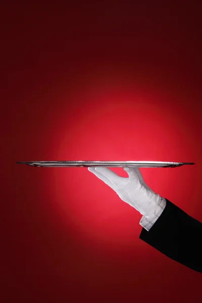 stock image Butler carrying silver serving tray, close-up of hand