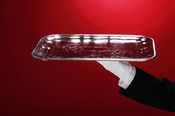 Butler carrying silver serving tray, close-up of hand — Stock Photo, Image