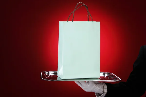 Portier nosi białe rękawiczki, trzymając torby na zakupy — Zdjęcie stockowe