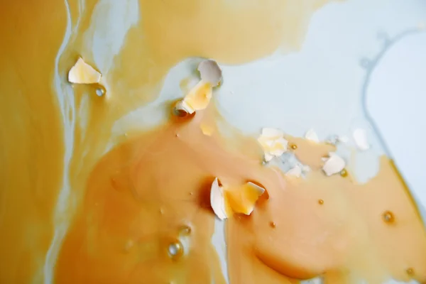 stock image Egg yolk and egg white splattered