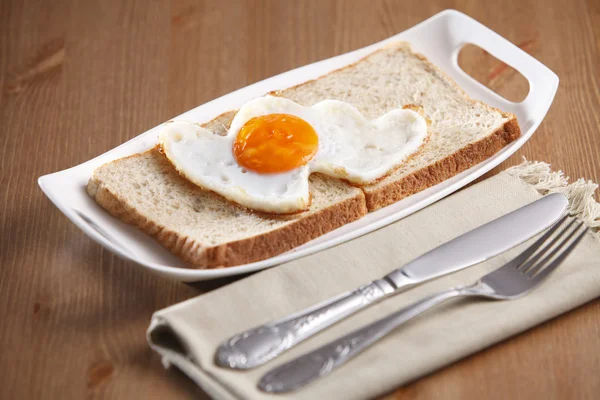 Love shape fried egg — Stock Photo, Image