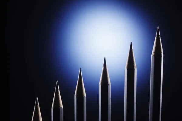 stock image Pencil form a graph on the dark background