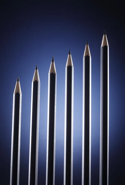 Pencil form a graph on the dark background — Stock Photo, Image