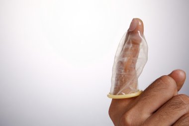 Stock image of the man holding condom clipart