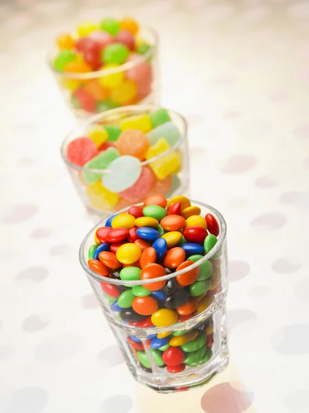 Candy arranged in a row — Stock Photo, Image