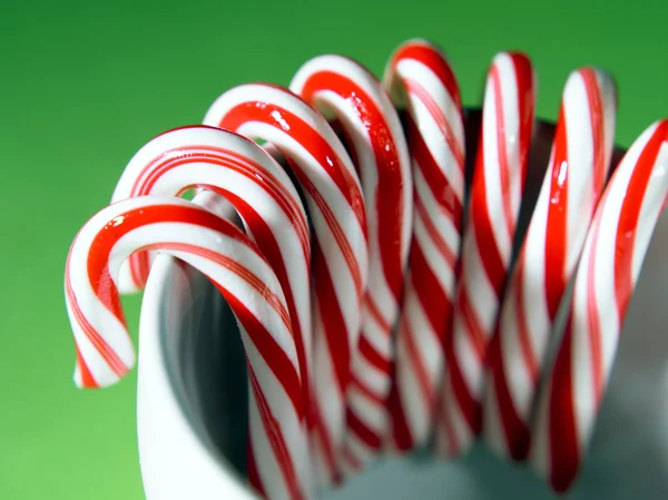 Candy cane on the greenn color background — Stock Photo, Image