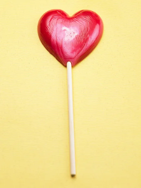 Heart shape lollipop on the color background — Stock Photo, Image