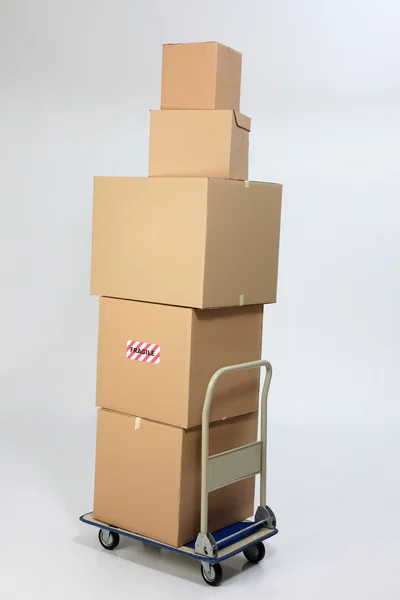 Box stack up on top of trolley — стоковое фото