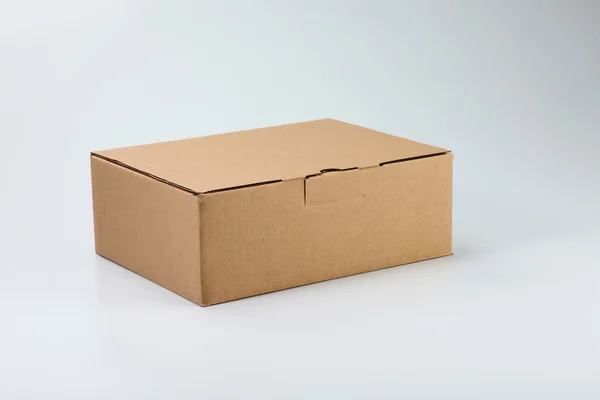 Brown color cardbox on the plain color background — Stock Photo, Image