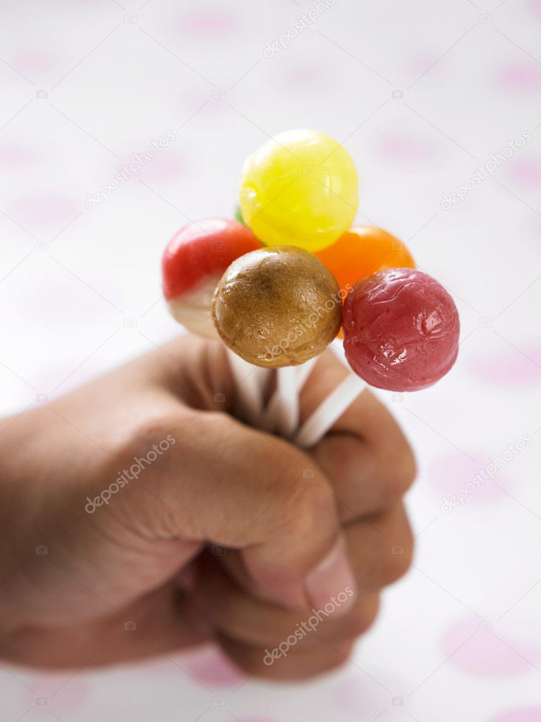 Hand holding a bunch of the lollipop