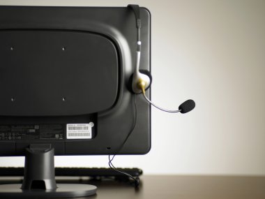 Back view of the monitor with an ear piece clipart