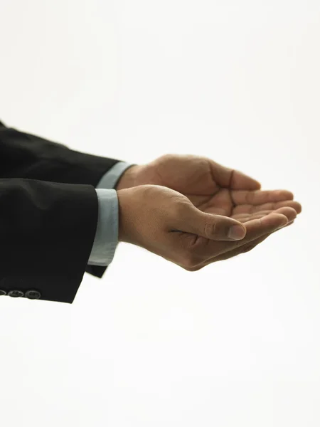 Un uomo d'affari che tende le mani a coppa . — Foto Stock