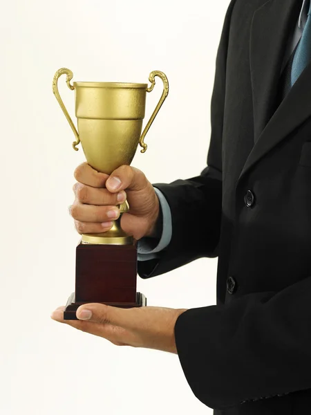 A winner with suit holding a throphy — Stock Photo, Image