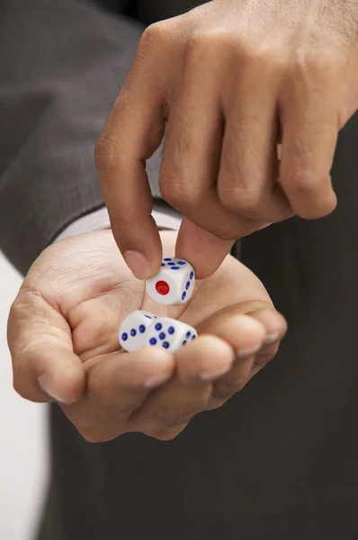 stock image Close up of man picking up a dice
