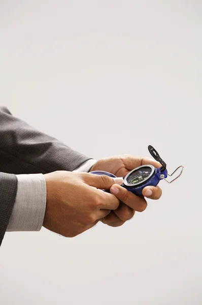 Man holding compass looking at the direction — Stock Photo, Image