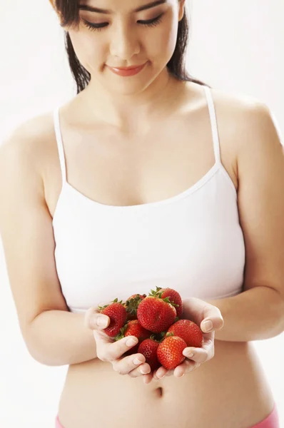 stock image Young woman holding strawberries