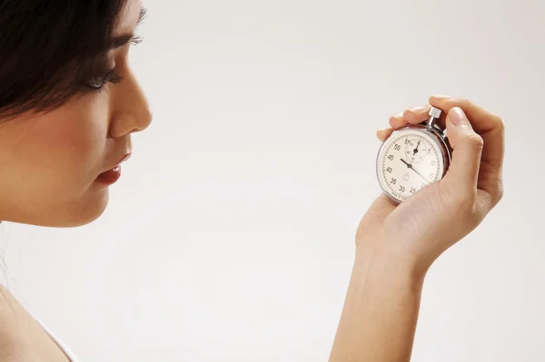 Νέα γυναίκα που κρατά ένα χρονόμετρο — Φωτογραφία Αρχείου
