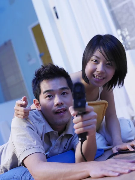 Man holding a game gadget aiming to the camera — Stock Photo, Image