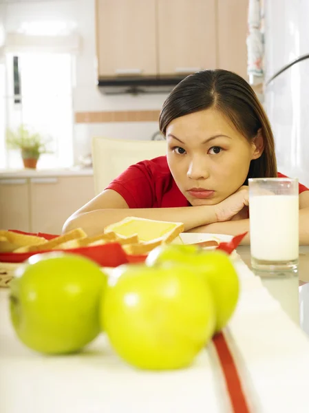 Mladá žena, sedí jí mléko — Stock fotografie