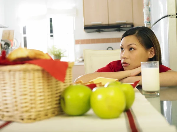 A young woman sitting by her milk — Stock Photo, Image