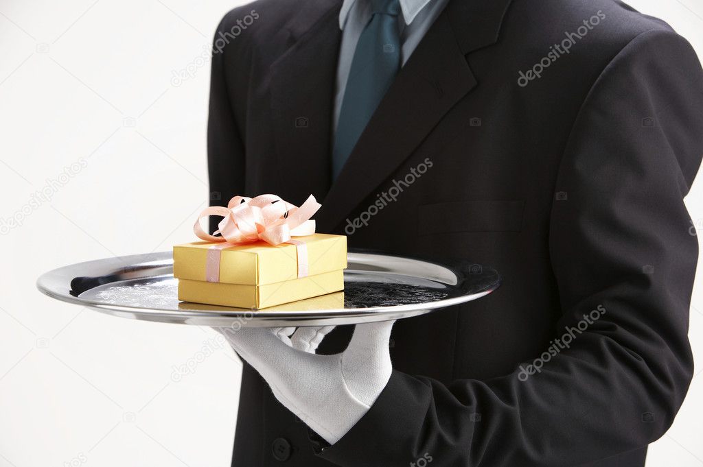 Saleman holding a sliver tray with gift
