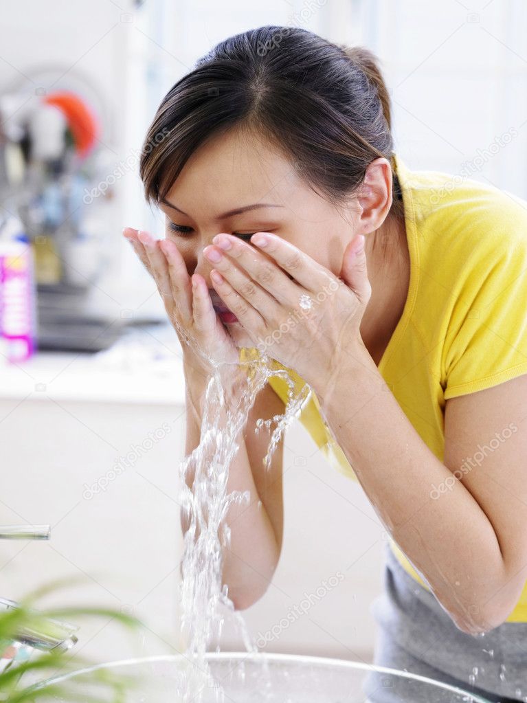 Young lady washing her face