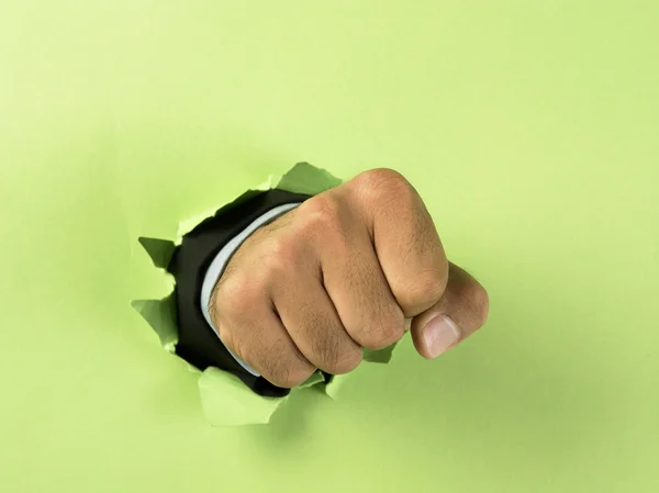 Hand breaking through paper — Stock Photo, Image