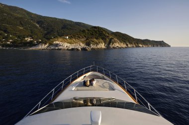 Italy, Elba Island, couple on a luxury yacht Azimut 75 at sunset clipart