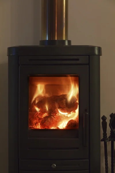 stock image Wood stove burning in a private house