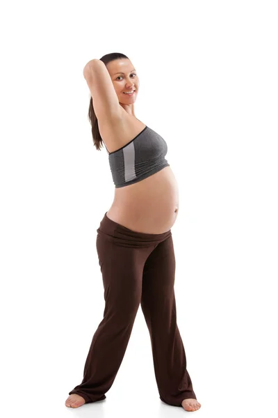 Schöne schwangere Frau macht Übungen — Stockfoto