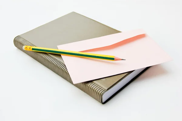 Bok, pennor och kuvert. bakgrunden är vit — Stockfoto