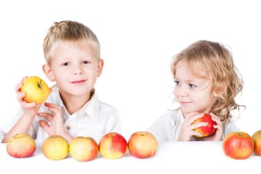 Two kids playing with apples isolated on white background clipart