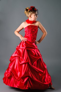 Teen girl posing in prom dress on studio neutral background clipart