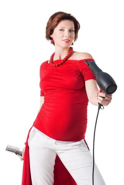 Young pregnant woman styling your hair with hairdryer — Stock Photo, Image