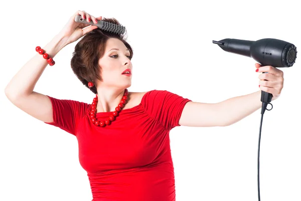 Young pregnant woman styling your hair with hairdryer — Stock Photo, Image