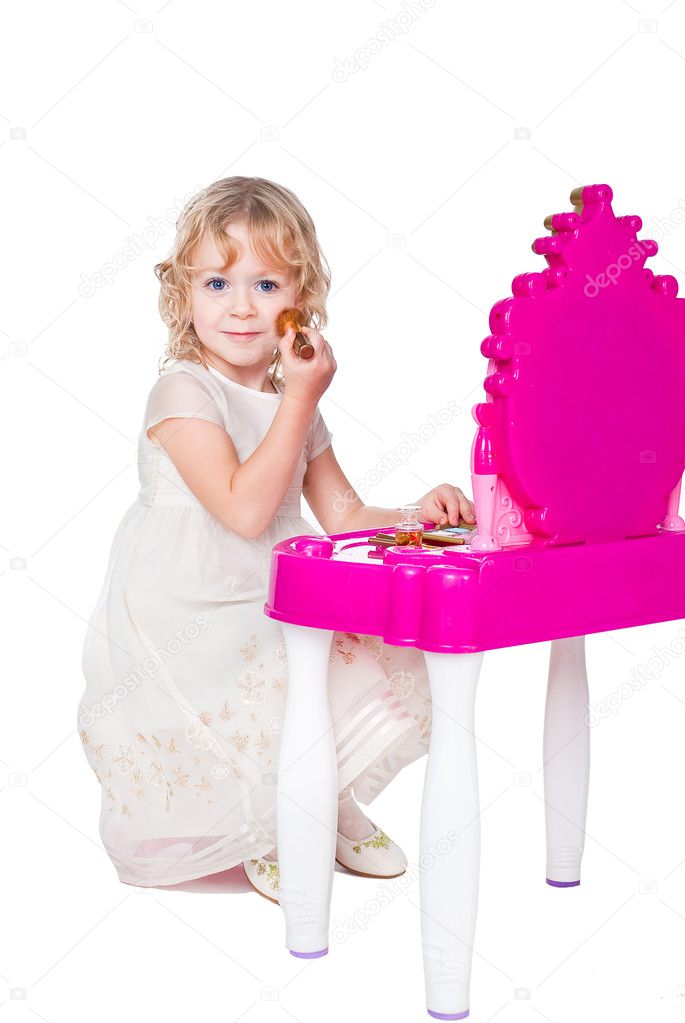 Little girl playing with makeup isolated on white background