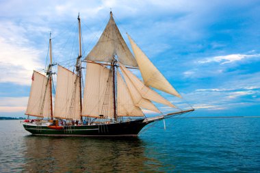 Old Style Sail Boat near Harbor clipart