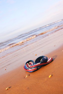 Pair of sandles on beach clipart