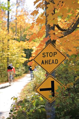 Stop Sign by the Bike Trail clipart