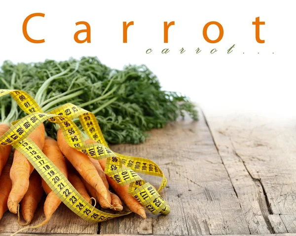 Measure tape and carrots — Stock Photo, Image