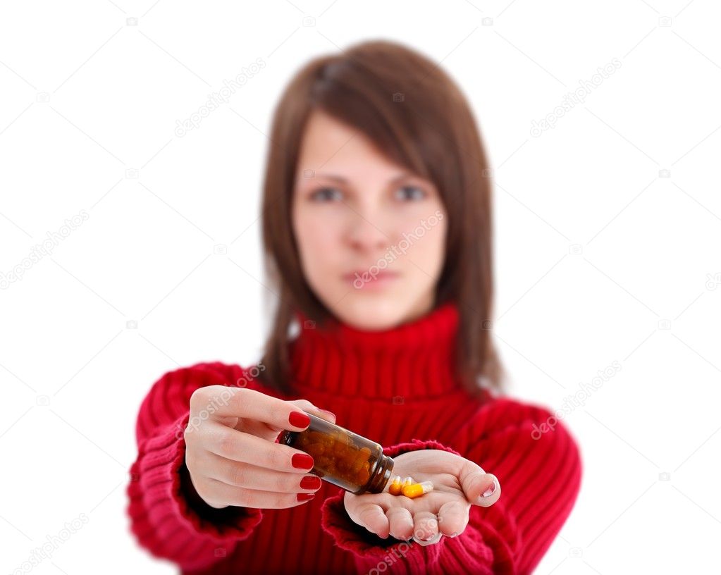 Young woman showing pills