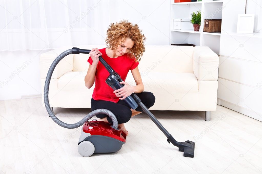 Woman repairs vacuum cleaner