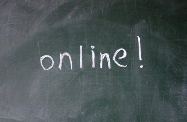 Online sign written with chalk on blackboard clipart