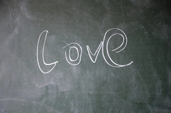 Love title written with chalk on blackboard — Stock Photo, Image