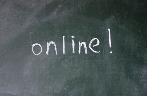 Online sign written with chalk on blackboard — Stock Photo, Image