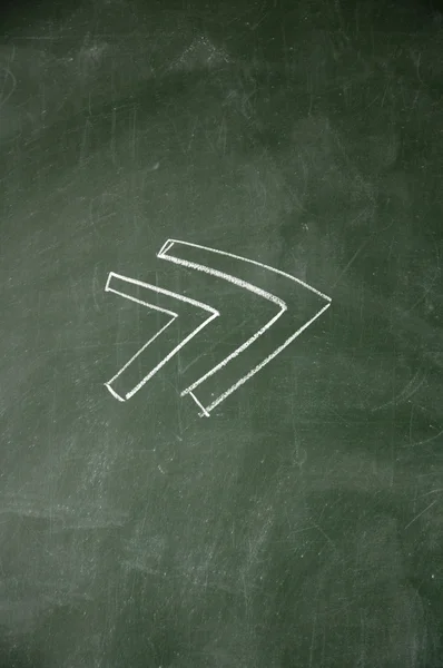 Arrows drawn with chalk on blackboard