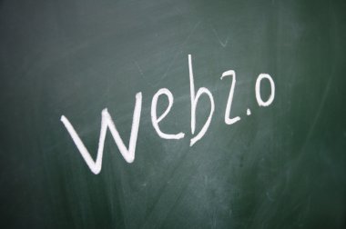 Web 2.0 sign written with chalk on blackboard clipart