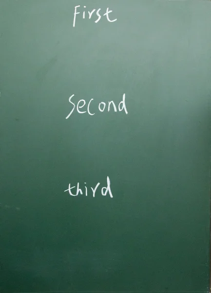 First second third written with chalk on blackboard — Stock Photo, Image