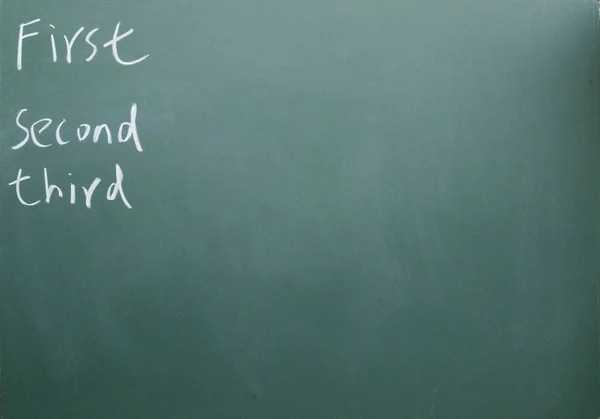 First second third written with chalk on blackboard — Stock Photo, Image